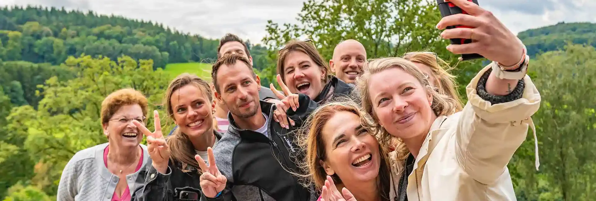 Eine Gruppe von Menschen macht ein Selfie im Schwarzwald am Standort der Sommerrodelbahn Gutach.
