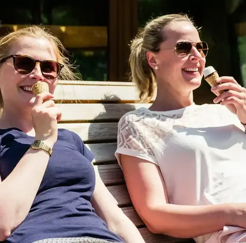 Zwei Frauen genießen ein Eis auf einer Parkbank am Standort der Sommerrodelbahn in Gutach.